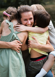 A mother embracing her children.